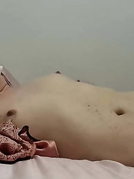 Smiling shemale harlot is taking off her underwear for a photoshoot