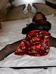 A Japanese crossdresser shemale in a straightjacket BDSM scene.