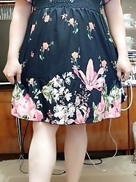 A transgender woman wears a dildo as a sex toy and strikes poses.