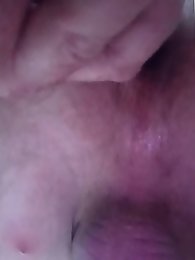 A beautiful ladyboy is standing on the street and posing for money